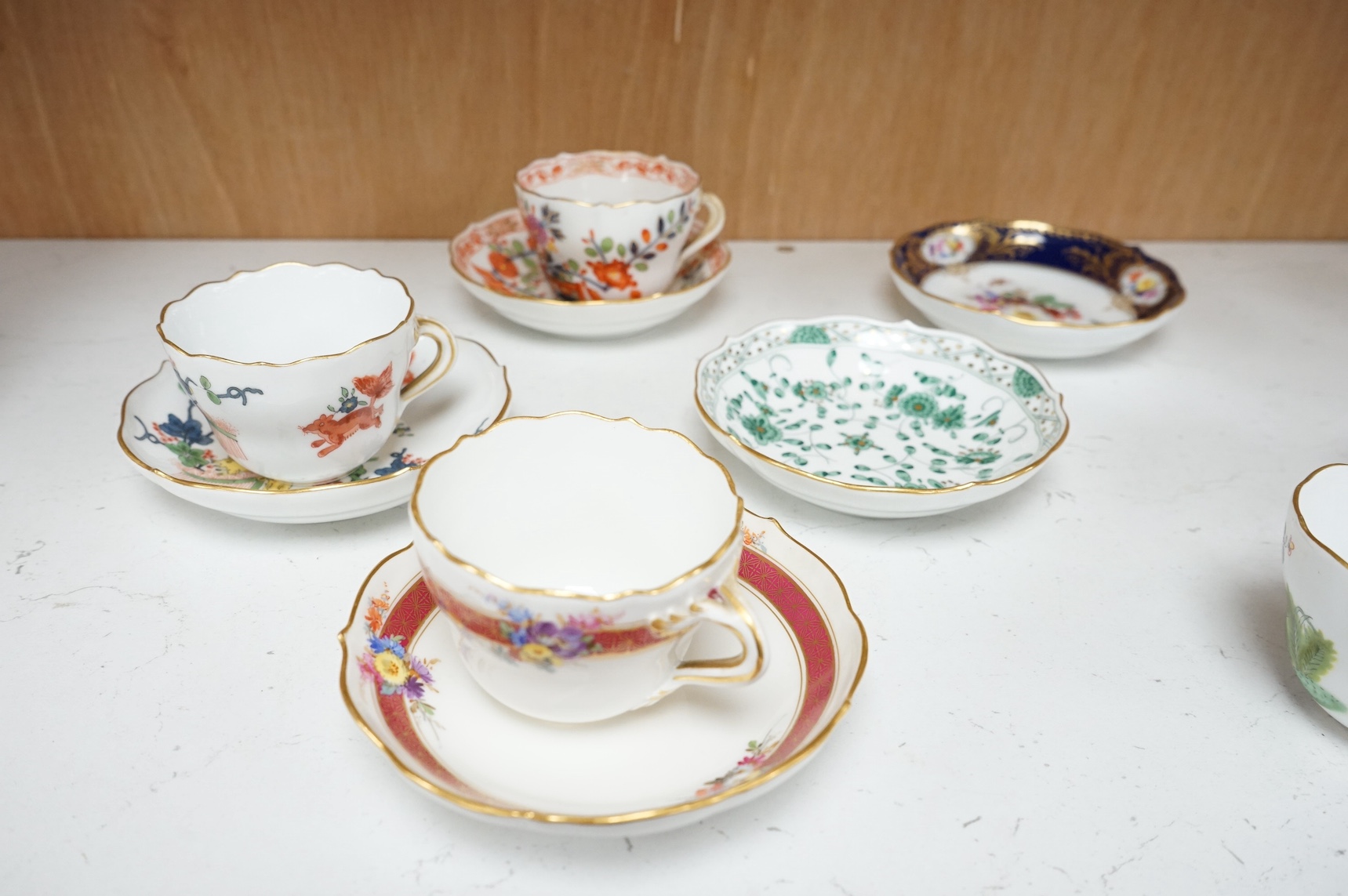 A collection of Meissen cabinet cups and saucers and four knife rests. Condition - varies